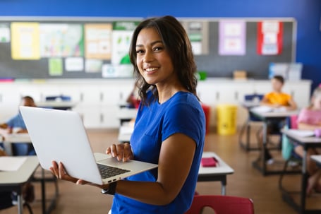 Teacher_Using_Laptop_In_Classroom_original_3111555